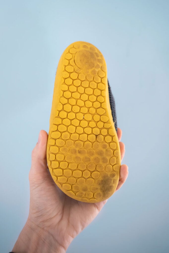 Testing the durability of Mukishoes, showing a worn kid's pair