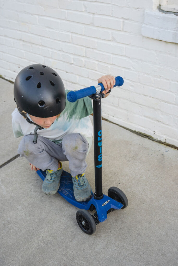 Kids riding scoot with affordable barefoot shoes from Saguaro