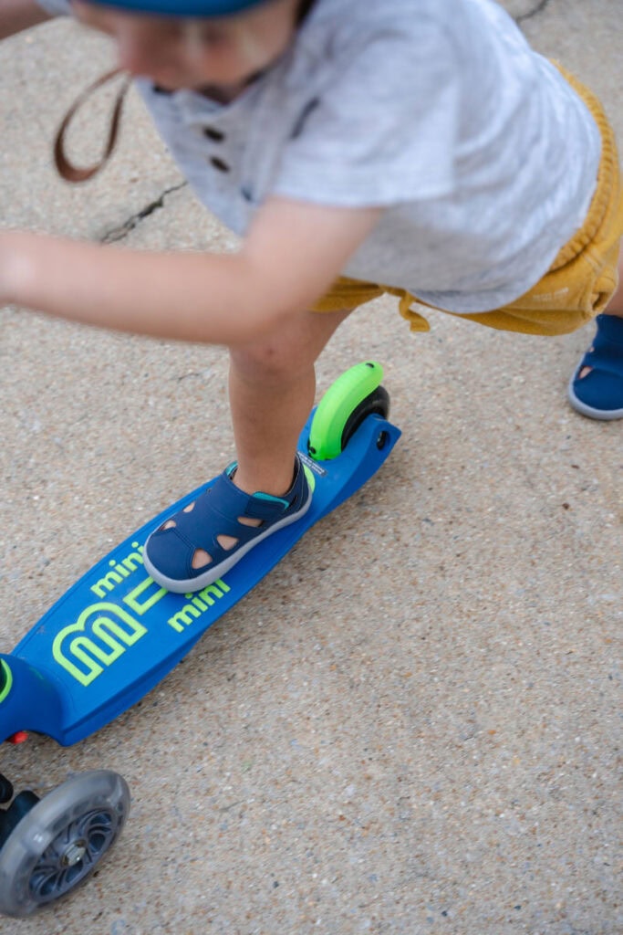Riding a micro mini scoot with ten little minimalist sandals