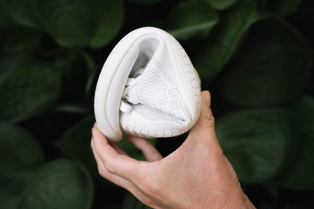 Flexibility of the Vivobarefoot Primus Lite Knit shown by rolling up the shoe into a ball